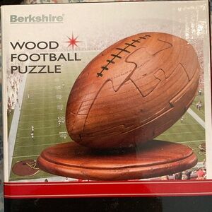 Berkshire NIB Brown Wooden Football Puzzle with a sturdy wooden pedestal.